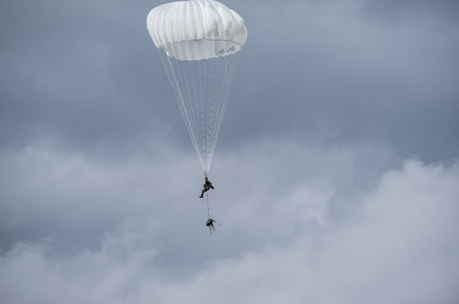 圖為9月11日，攜裝跳傘訓練隊員向指定區域降落。中新社
